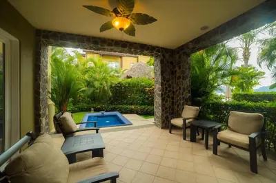 a patio with chairs and a swimming pool at Vista Bahia 3D - 3bdr 3bath plunge pool in Herradura