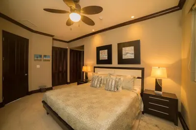 a bedroom with a bed and a ceiling fan at Vista Bahia 3D - 3bdr 3bath plunge pool in Herradura