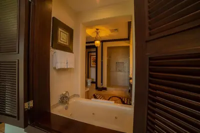 a bathroom with a tub and a large mirror at Vista Bahia 3F 1 bedr 1 1 and a half bath ocean view in Herradura