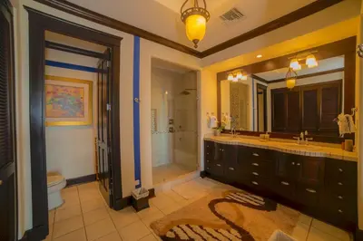 a bathroom with a large mirror and a sink at Vista Bahia 3F 1 bedr 1 1 and a half bath ocean view in Herradura