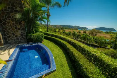a swimming pool in the yard of a house at Vista Bahia 3F 1 bedr 1 1 and a half bath ocean view in Herradura