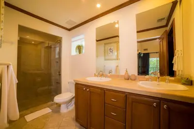 a bathroom with two sinks and a shower at Veranda 2B - 3 bdr 3 bath in La Mona