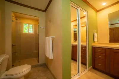 a bathroom with a toilet and a glass shower at Veranda 3G 2 bedr 2 bath in La Mona