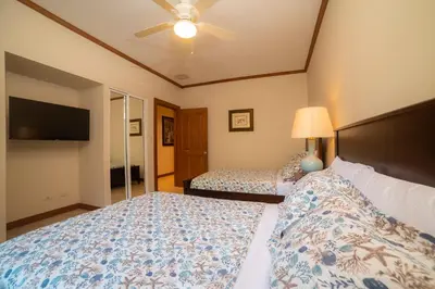 a bedroom with two beds and a flat screen tv at Veranda 3G 2 bedr 2 bath in La Mona