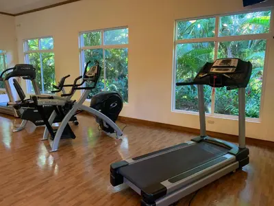 a gym with two exercise bikes and two windows at Veranda 3G 2 bedr 2 bath in La Mona