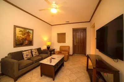 a living room with a couch and a flat screen tv at Veranda 3G 2 bedr 2 bath in La Mona