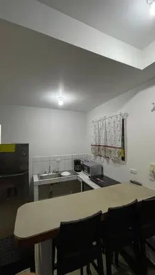 a kitchen with a table and chairs in a room at Comfort Near the Sea Valgreenplace Herradura in Herradura