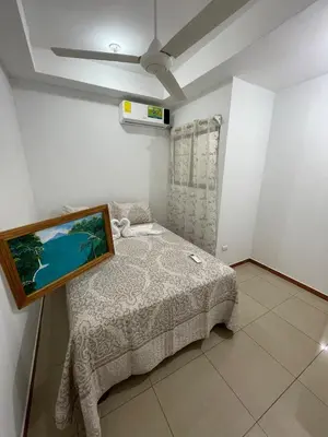 a bedroom with a bed with a picture on it at Comfort Near the Sea Valgreenplace Herradura in Herradura