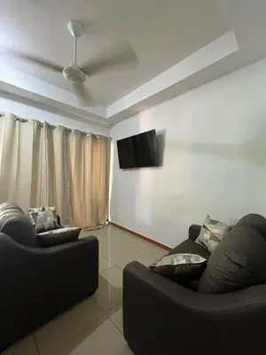 a living room with two couches and a flat screen tv at Comfort Near the Sea Valgreenplace Herradura in Herradura