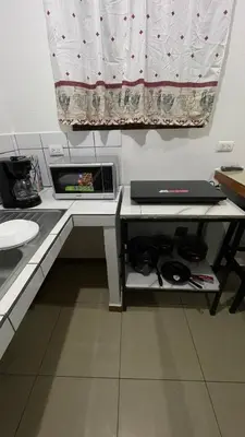 a small kitchen with a table with a laptop on it at Comfort Near the Sea Valgreenplace Herradura in Herradura