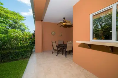 a patio with a table and chairs and a window at Veranda 4F - 2 bdr -2 bath in La Mona