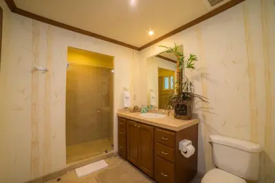 a bathroom with a toilet and a sink and a shower at Veranda 4F - 2 bdr -2 bath in La Mona