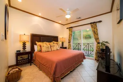 a bedroom with a bed and a tv and a window at Veranda 5A - 1 bdr 1 bath in La Mona