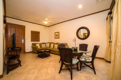 a living room with a couch and a table and chairs at Veranda 5A - 1 bdr 1 bath in La Mona