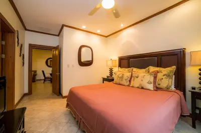 a bedroom with a bed with orange sheets and pillows at Veranda 5A - 1 bdr 1 bath in La Mona