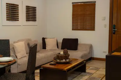 a living room with a couch and a table at Veranda 5H - 1 Bedr 1 Bath in La Mona