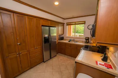 a kitchen with wooden cabinets and a stainless steel refrigerator at Veranda 8F - 2 bdr 2 bath - Condo in La Mona