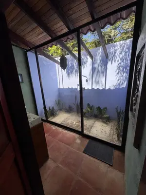 an outside view of a fish tank in a house at Cabuya Lodge in Cabuya