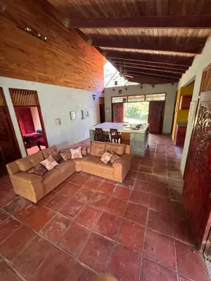 a large living room with couches and a table at Cabuya Lodge in Cabuya