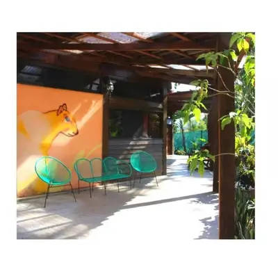 a group of chairs and a wall with a painting of a horse at Cabuya Lodge in Cabuya
