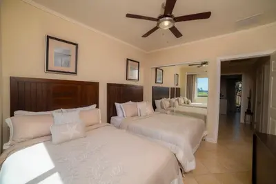 a bedroom with two beds and a ceiling fan at Del Mar 2J - 3bdr- 2bth Ocean view in Jacó