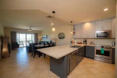 a kitchen and living room with a table and a dining room at Del Mar 2J - 3bdr- 2bth Ocean view in Jacó