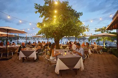 a group of people sitting at tables in a restaurant at Del Mar 2J - 3bdr- 2bth Ocean view in Jacó