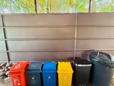 a row of trash cans sitting next to a fence at 2 Tiny Houses Private Pool Volcano View 6 people in Fortuna