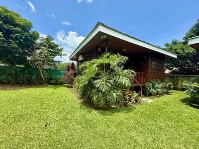a small house with a grass yard next to it at 2 Tiny Houses Private Pool Volcano View 6 people in Fortuna