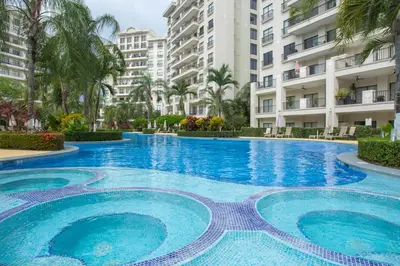 a large swimming pool with blue water in front of buildings at Jaco Bay 4303 in Jacó