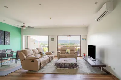 a living room with a couch and chairs and a television at Jaco Bay 4303 in Jacó