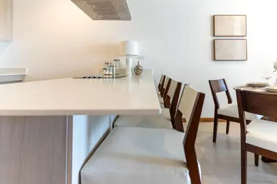 a kitchen and dining room with a table and chairs at Selva Coral 0701 in Jacó
