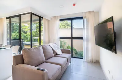 a living room with a couch and a large window at Torres del Mar 1202 in Jacó