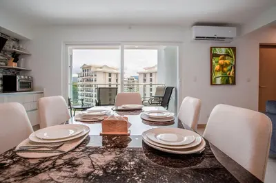 a dining room with a table and chairs at Viva Jaco Viva Jaco (10-03B) in Jacó