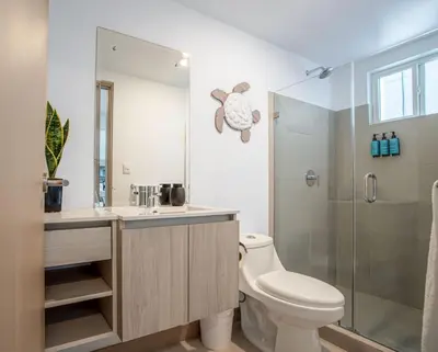 a bathroom with a toilet and a shower at Viva Jaco Viva Jaco (10-03B) in Jacó