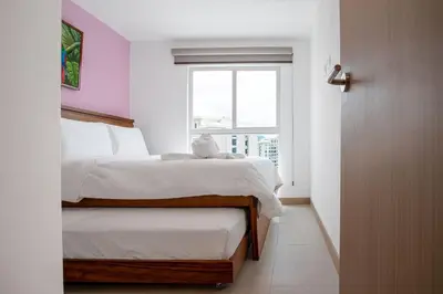 a bedroom with a bed and a window at Viva Jaco Viva Jaco (10-03B) in Jacó