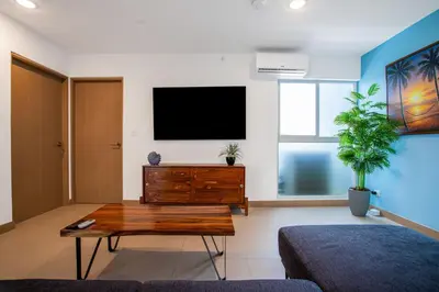 a living room with a flat screen tv on a wall at Viva Jaco Viva Jaco (10-03B) in Jacó