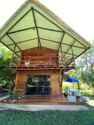 a house with a large roof with a patio at Casa Oropéndola Refugio natural en Guanacaste in Bagaces