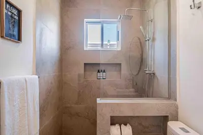 a bathroom with a shower with a glass door at Casa Ocean with Studio -Triskele Retreat in Esterillos