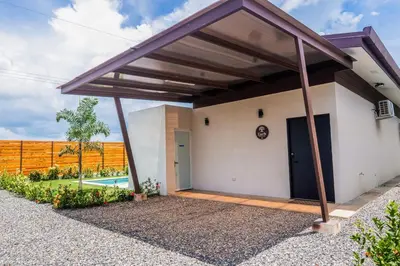 a garage with awning on the side of a house at Entire Property - Triskele Retreat in Esterillos