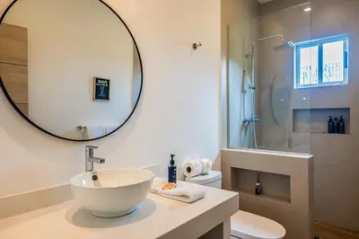 a bathroom with a sink and a mirror at Entire Property - Triskele Retreat in Esterillos