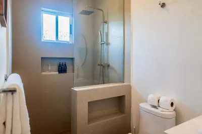 a bathroom with a shower and a toilet at Entire Property - Triskele Retreat in Esterillos
