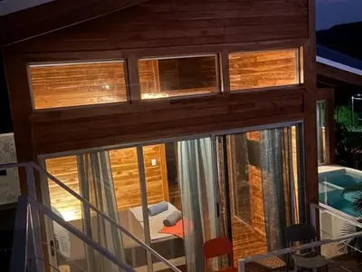 a room with a view of a house at luxury wooden house mountain view in Hojancha