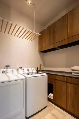 a kitchen with a washer and dryer in it at Ohana Villa - Ocean View and a Walk to the Beach in Nosara