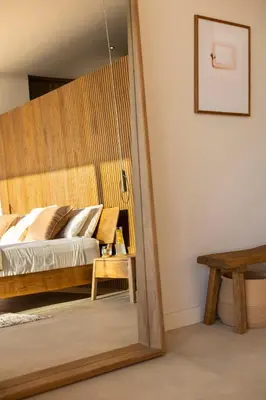 a bedroom with a bed and a mirror at Ohana Villa - Ocean View and a Walk to the Beach in Nosara