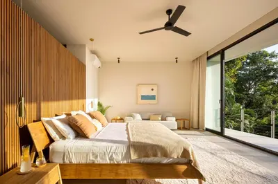 a bedroom with a bed and a ceiling fan at Ohana Villa - Ocean View and a Walk to the Beach in Nosara