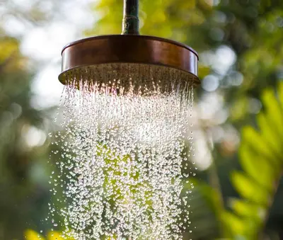a droplet of water hanging from a bird feeder at Nalu Nosara Pool Villa Flor in Nosara