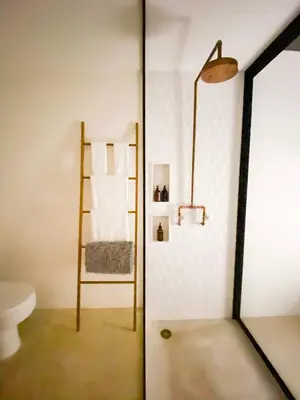 a bathroom with a toilet and a ladder at Nalu Nosara Pool Villa Flor in Nosara