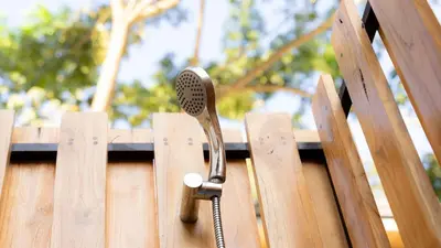 a hairdryer sticking out of a wooden fence at New! 5-Min Walk to Surf - Private Pool - 2BR in Playa hermosa