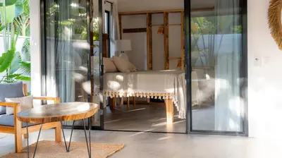 a living room with a bed and a table at New! 5-Min Walk to Surf - Private Pool - 2BR in Playa hermosa